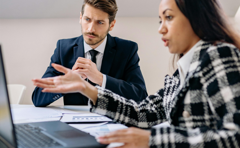 Healthcare leader reviewing physician burnout treatment assessment data on laptop showing distress trends